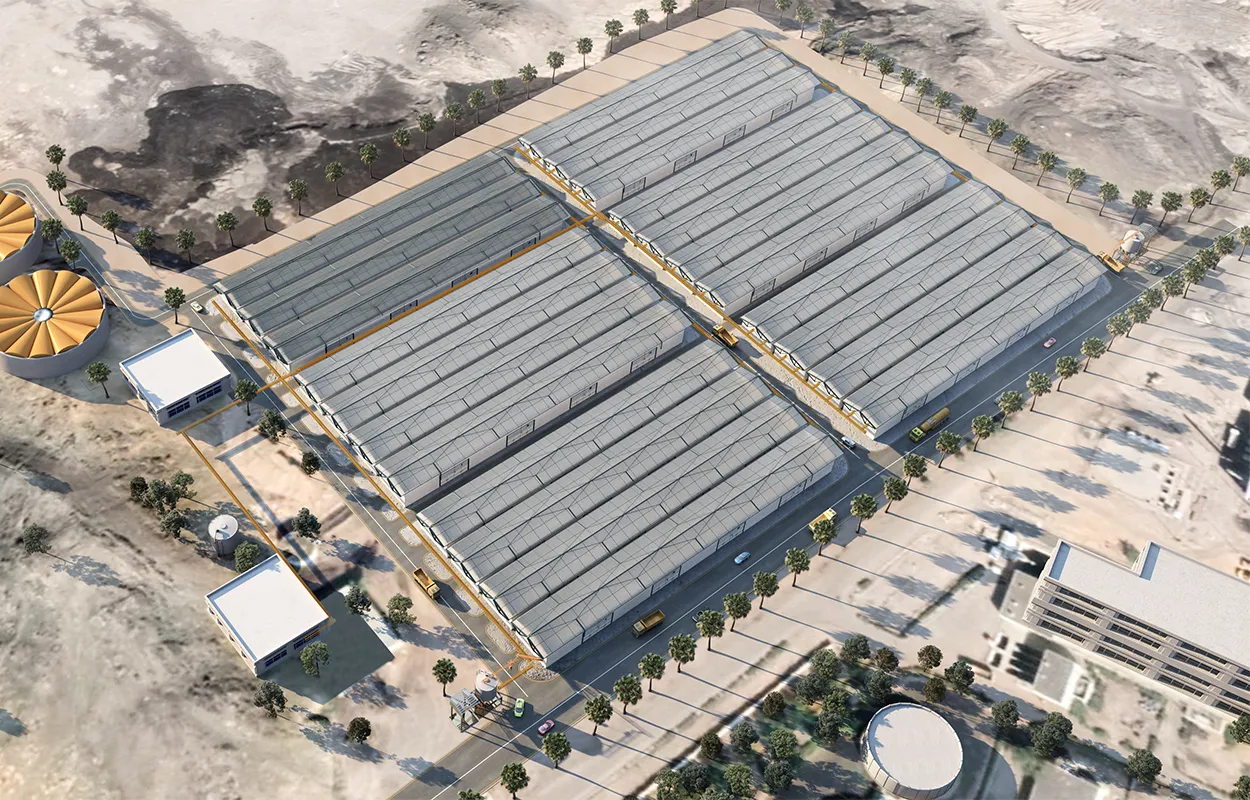 Aerial view of a large industrial or logistics facility with multiple long warehouse buildings, surrounded by roads, palm trees, and support infrastructure in a desert environment.