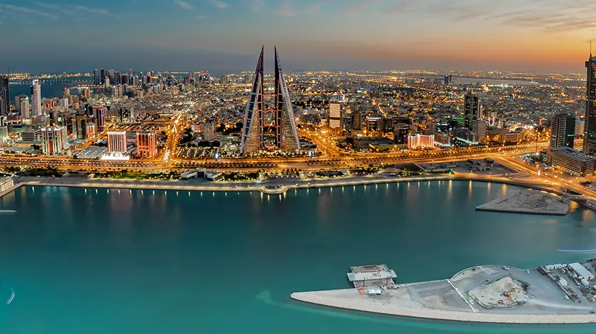Aerial view of Manama, Bahrain, with the Bahrain World Trade Center and surrounding cityscape, highlighting the Kingdom’s water master planning and sustainability efforts.