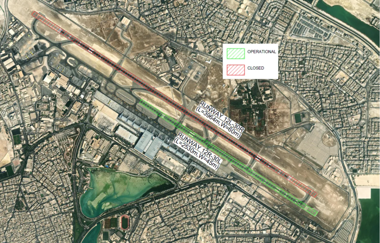 Satellite view of an airport showing two runways labeled 12L-30R and 12R-30L, with one marked operational and the other closed, surrounded by urban development and airport infrastructure.