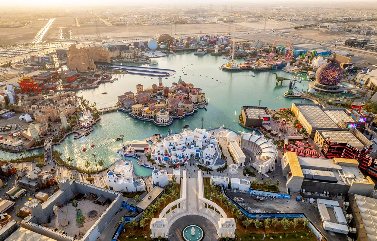 Aerial view of Boulevard World Riyadh showing artificial lake, themed attractions, and large-scale sports facilities and recreation infrastructure.
