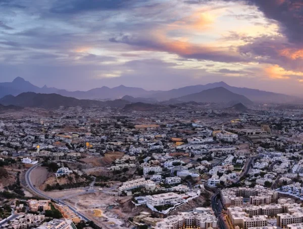 Landscape and public realm design in Oman illustrating regional urban growth, infrastructure networks, and integration with natural mountainous surroundings.