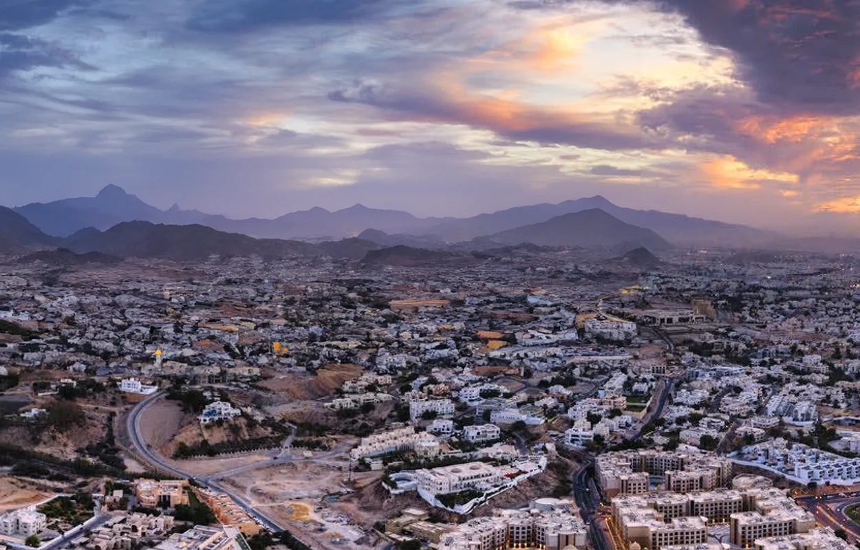 Landscape and public realm design in Oman illustrating regional urban growth, infrastructure networks, and integration with natural mountainous surroundings.