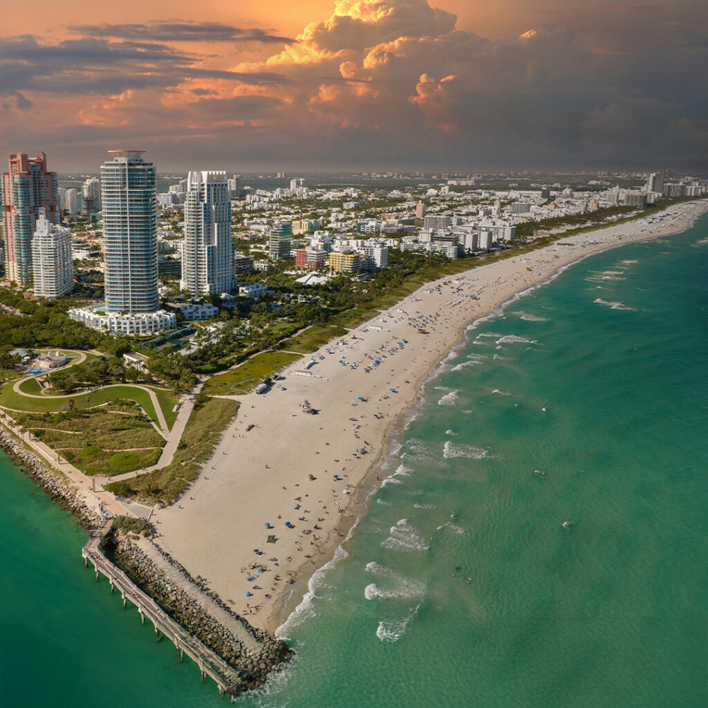 Aerial view of a coastal city and shoreline showing how urban planning and infrastructure can support ocean resilience.