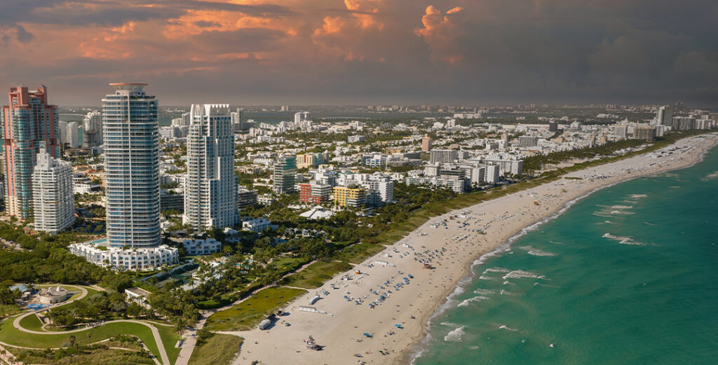 Aerial view of a coastal city and shoreline showing how urban planning and infrastructure can support ocean resilience.